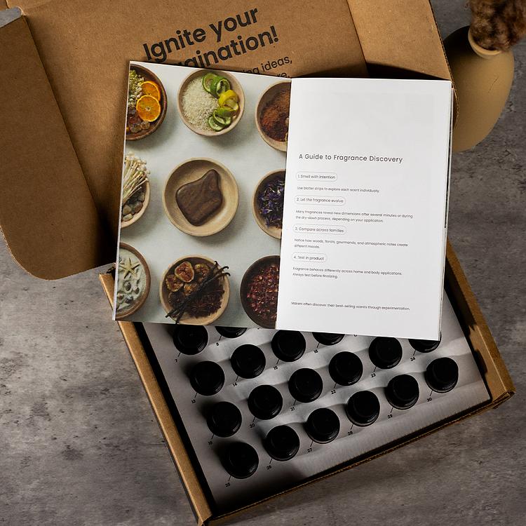 An open 30 pc luxury collection box, well organized with bottles still in each slot, with an elegant insert on top of the bottles.