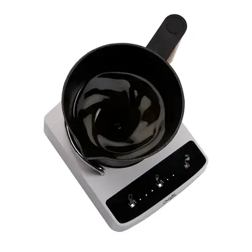 The Candle Maker mixing soy candle wax and fragrance oil