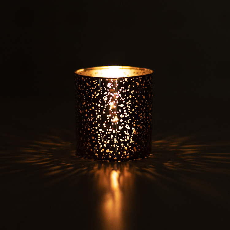 Mercury Tumbler in the dark with a lit candle