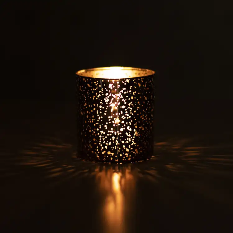 Mercury Tumbler in the dark with a lit candle