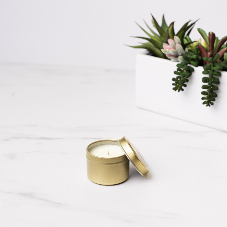 2 oz Gold Candle Tin with Planter in Background