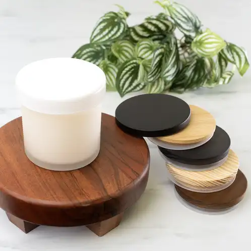 Frosted Tumbler Jar with Glass Tumbler Lid and Wooden Pine Lids on display