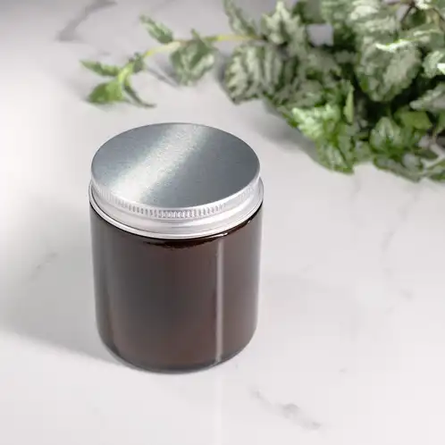 Small Amber Straight Sided Jar (Threaded) filled with candle and silver lid