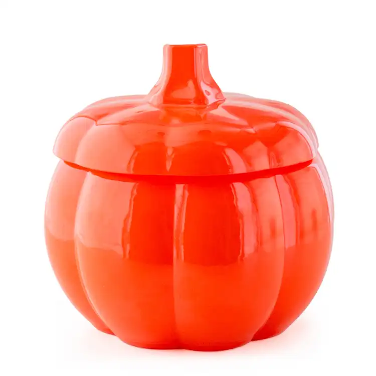 An orange pumpkin jar with a stem lid. 