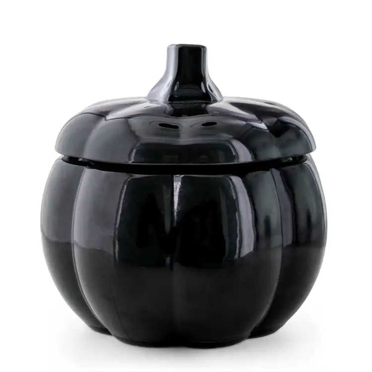 A black pumpkin jar with stem lid