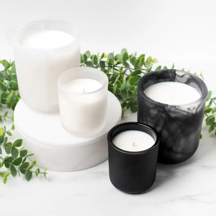 Frosted White Swirl Sonoma, Mini Frosted Sonoma, Frosted Black Swirl Sonoma, and Mini Matte Black Sonoma on white marble surrounded by ivy.