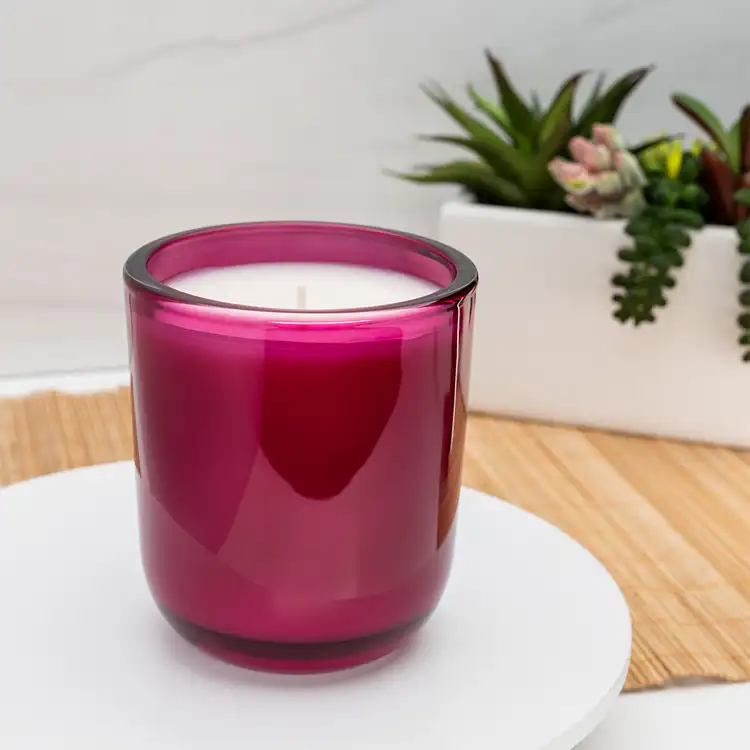 Merlot Sonoma Tumbler Jar candle in front of plants