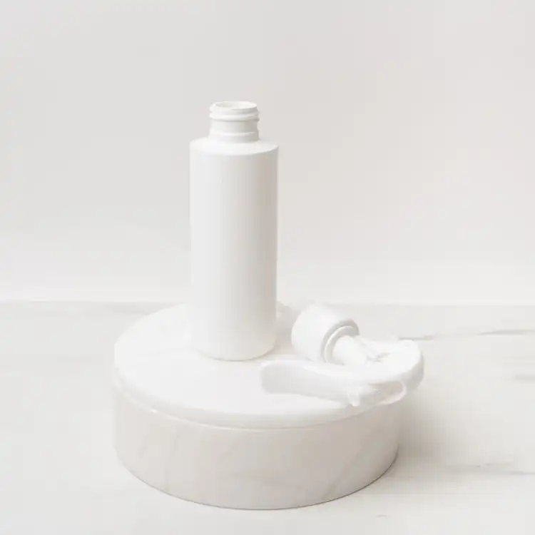 Matte White 4 oz. HDPE Bottle beside White Fine Mist Sprayers (24mm-410)