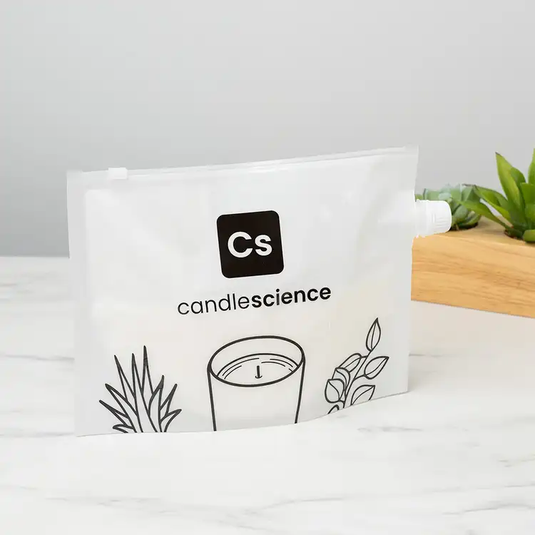 CandleScience Coconut Apricot Wax in Heat Safe Bag with a pour spout on a marble countertop