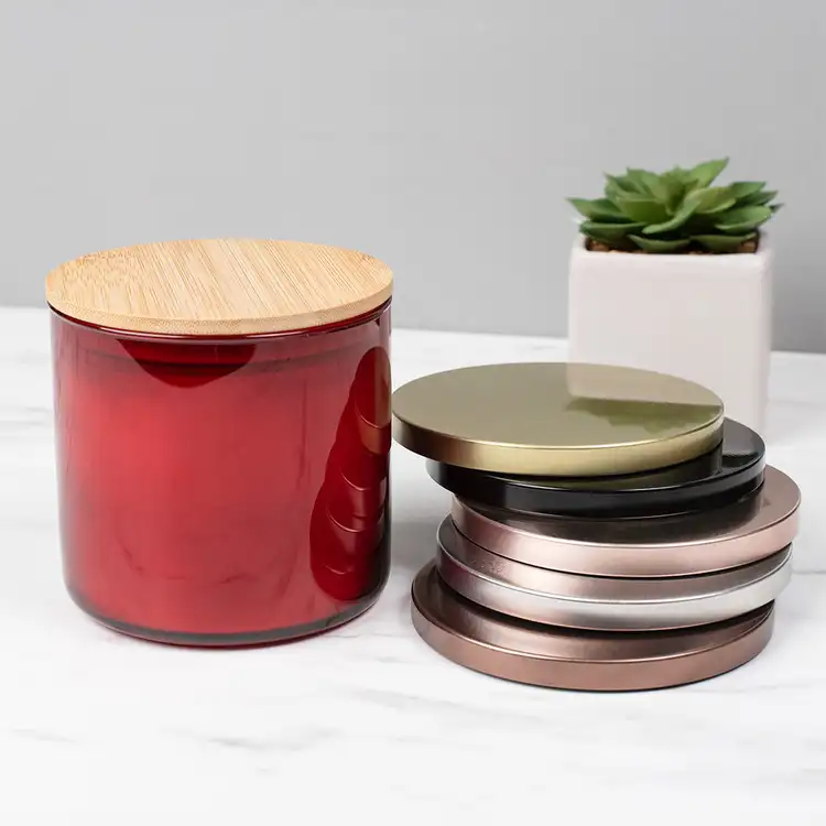 Red 3-Wick Tumbler Jar candle with 4" Bamboo Lid and assorted Metal Flat Lids (3-Wick) in front of plant