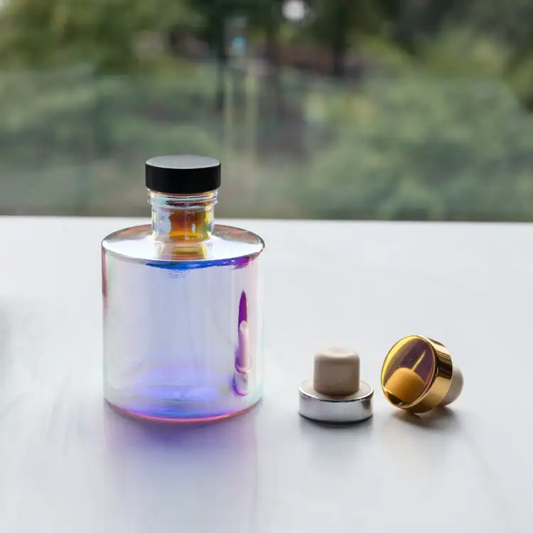 Prism Round Reed Diffuser Bottle with Matte Black Bottle Stopper in front of window, next to Gold and Silver Bottle Stoppers