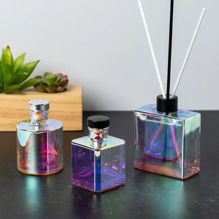 A group shot of the square, cube, and round prism reed diffuser bottles