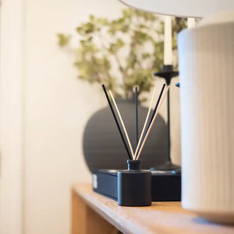 Matte Black Round Reed Diffuser Bottle in warm home setting