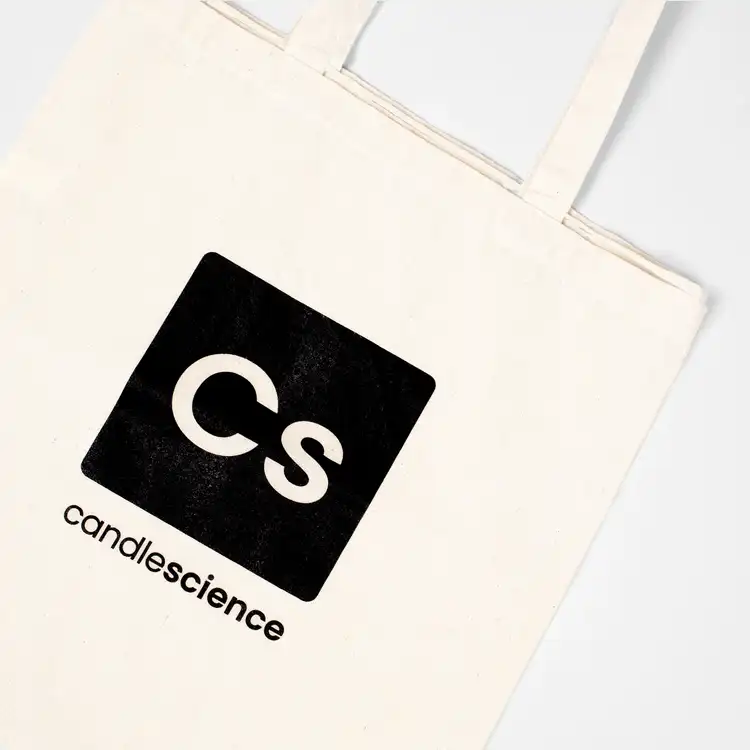 Close up on logo of Canvas CandleScience Tote Bag flat lay on white background