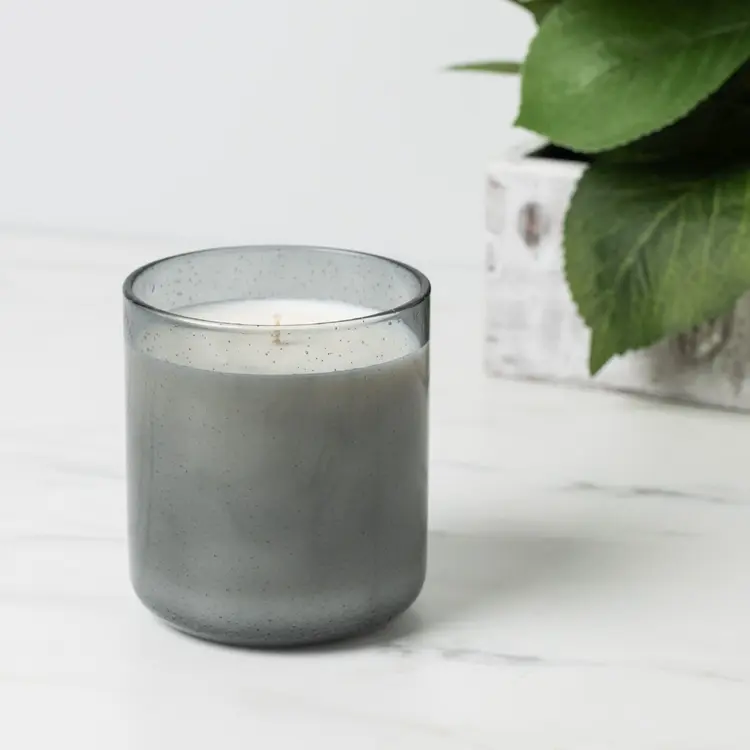 Stone Bubble Tumbler Jar candle in front of plant