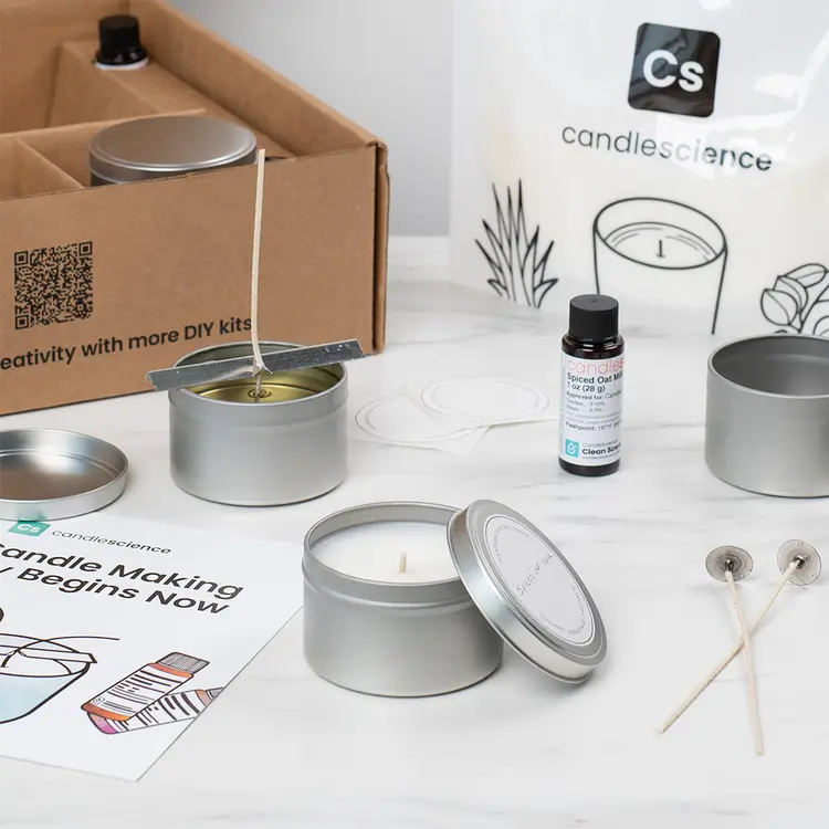 Candle Making Starter Kit partially made series of candles in tins. 