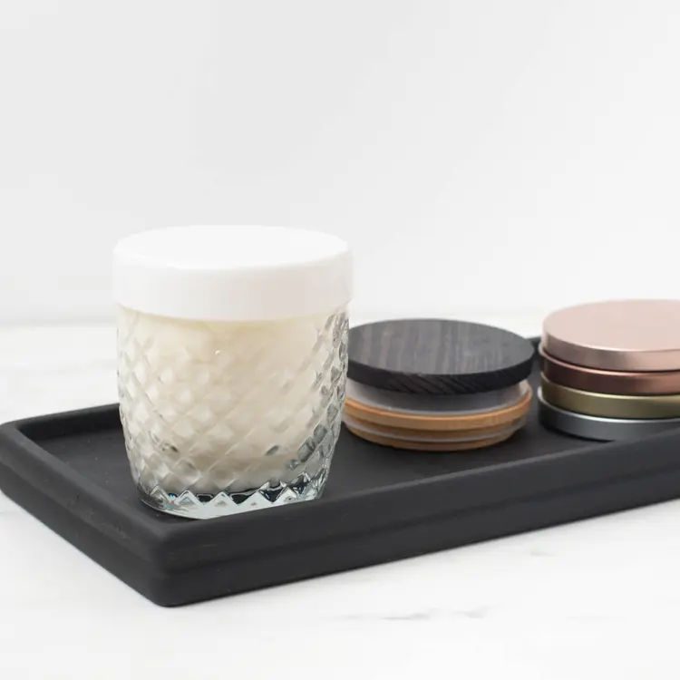 10 oz. Cross Hatch Rocks Tumbler Jar with a white glass Tumbler Lid and finished candle on a black wooden tray