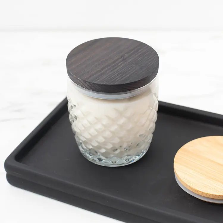 10 oz. Cross Hatch Rocks Tumbler Jar with a Pine Wooden Lid on a finished candle on a black wooden tray