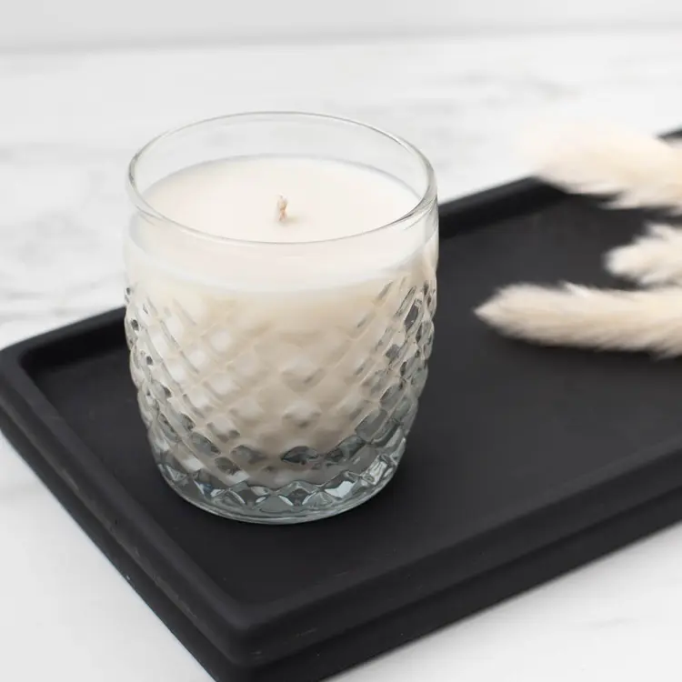 10 oz. Cross Hatch Rocks Tumbler Jar with a finished candle on a black wooden tray