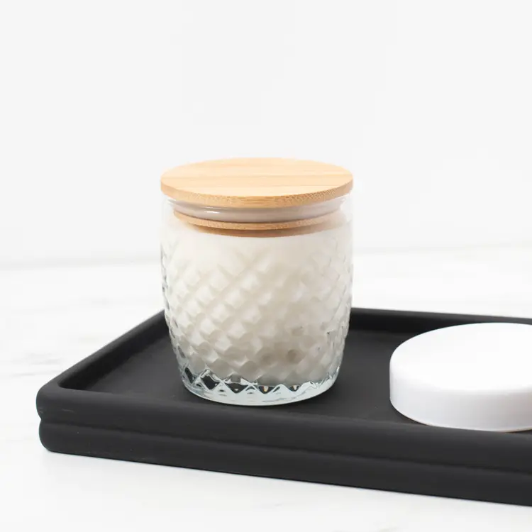 10 oz. Cross Hatch Rocks Tumbler Jar with a finished candle with a bamboo lid on a black wooden tray