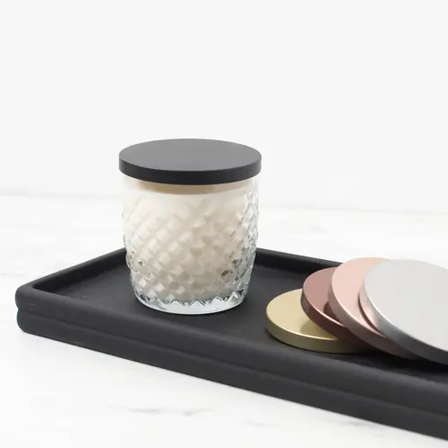 10 oz. Cross Hatch Rocks Tumbler Jar with a metal flat lid on a finished candle on a black wooden tray