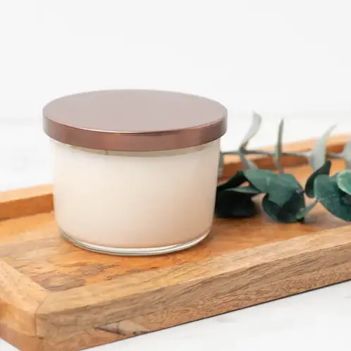 13.25 oz. Cidra Glass Tumbler Jar filled candle with a metal flat lid on a wooden tray