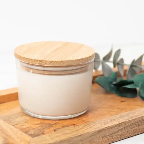 13.25 oz. Cidra Glass Tumbler Jar filled candle with a bamboo lid on a wooden tray