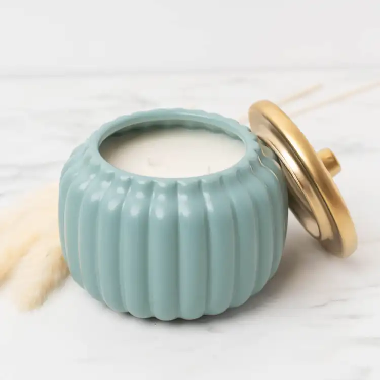 Harvest Teal Ceramic Pumpkin Jar on a marble background with pampas gras