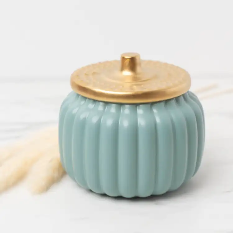 Harvest Teal Ceramic Pumpkin Jar on a marble background with pampas gras