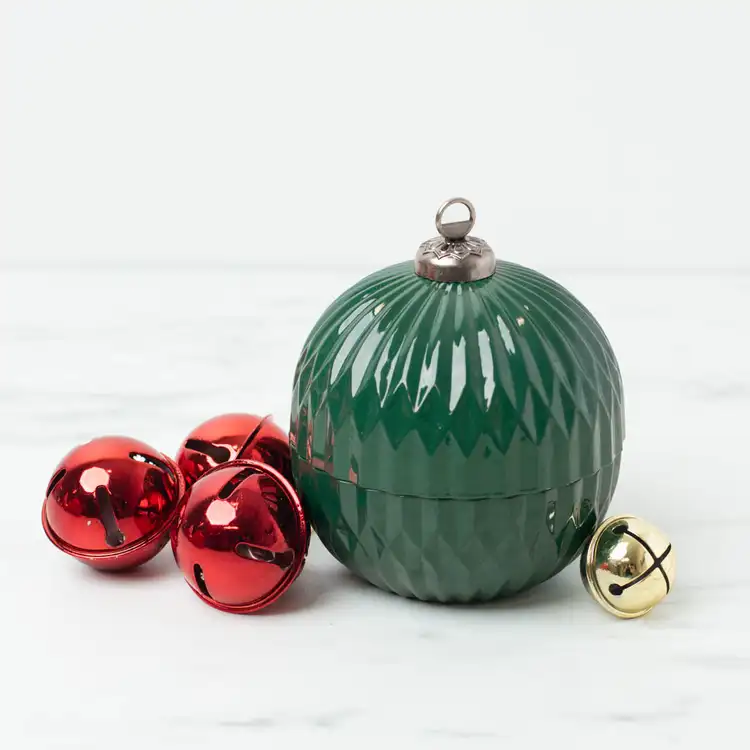Green Glass Ornament Jar marble countertop with red and gold bells