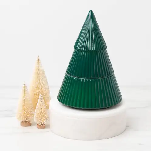 Green Glass Tree Jar on a white pedestal and marble countertop