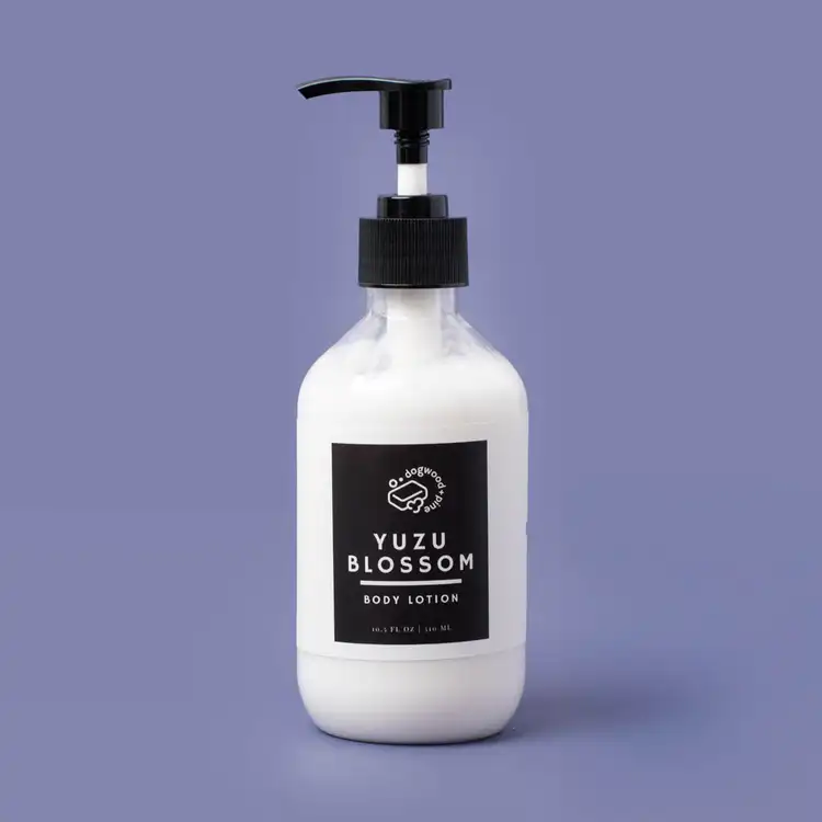 A a finished lotion base in elegant packaging on a purple background