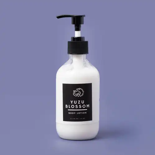 A a finished lotion base in elegant packaging on a purple background