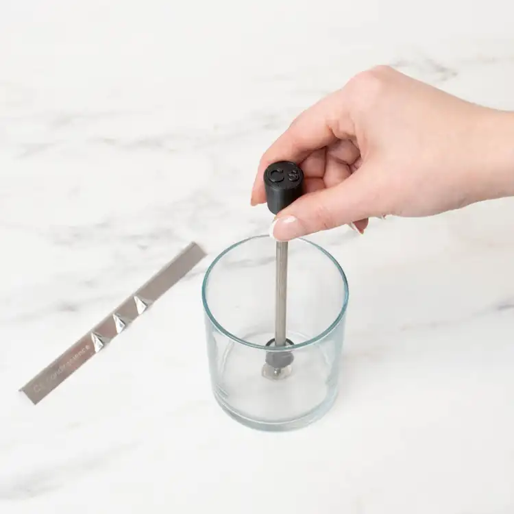 CandleScience Small Single Wick Setter pressed into a clear straight sided tumbler jar