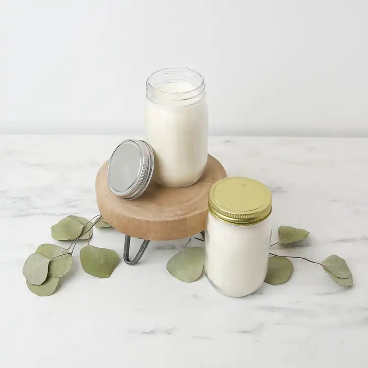 16 oz. Canning Jar filled with wax and wick on a marble countertop