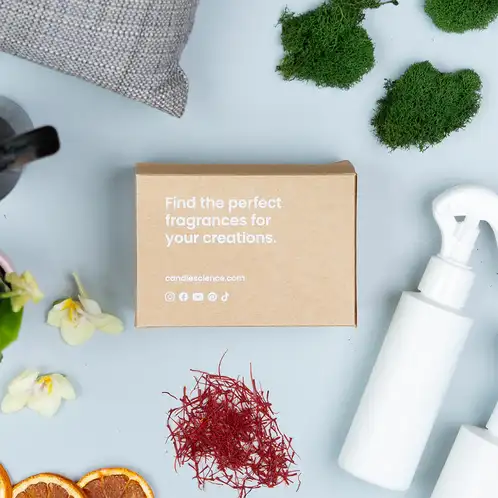 Room Spray Favorites fragrance flight kraft box on a blue table with moss, saffron threads, and room spray bottles