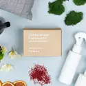 Room Spray Favorites fragrance flight kraft box on a blue table with moss, saffron threads, and room spray bottles