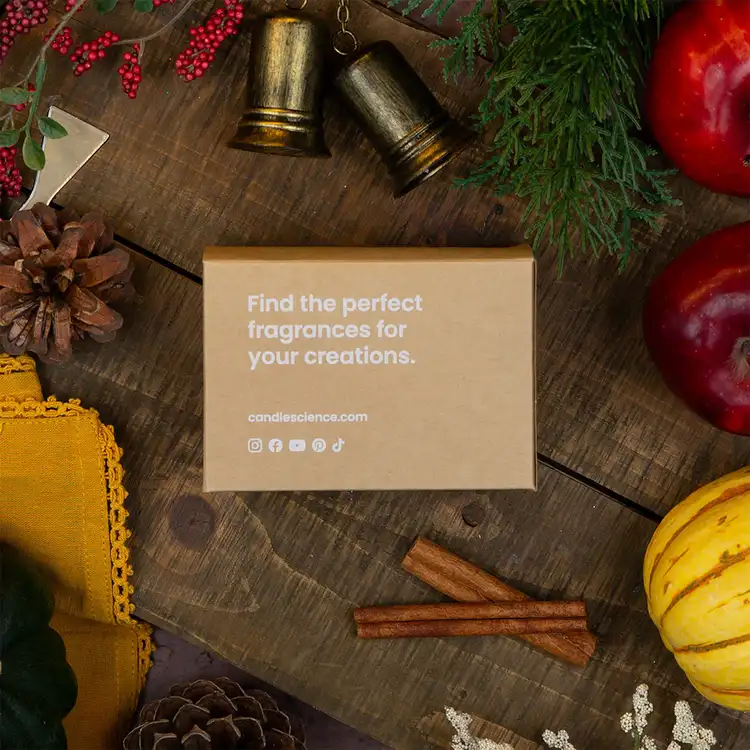 Harvest and Hearth Fragrance Flight Box and 1 oz Fragrance Oils in a kraft box on a wooden table with cinnamon and spices around is