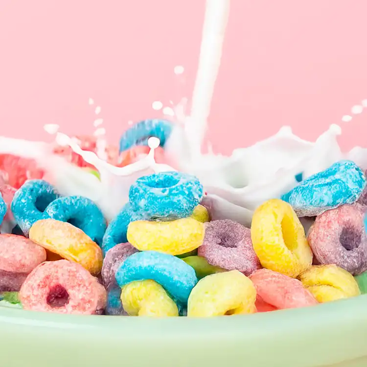 Cereal milk swirl: A bowl of colorful cereal rings with milk pouring into the bowl.