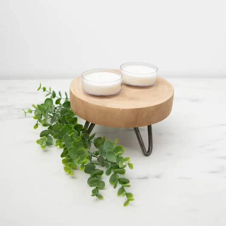 TWo Clear Plastic Wide Tealight Cups on a wooden tray with greenery