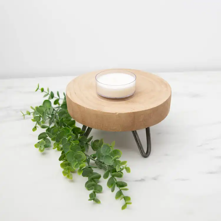 TWo Clear Plastic Wide Tealight Cups on a wooden tray with greenery