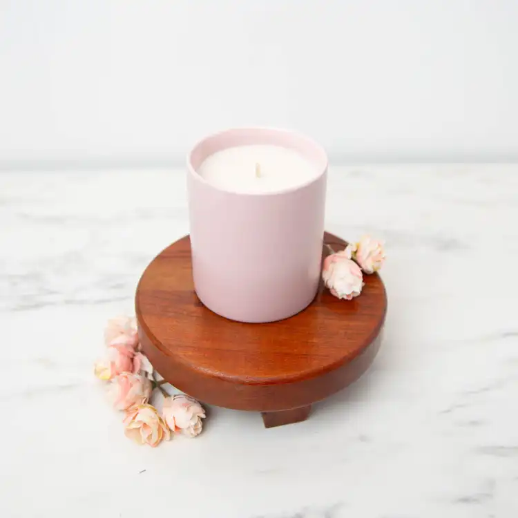 Blush Modern Ceramic Tumbler with no lid on a wooden pedestal with rose buds scattered around the container 