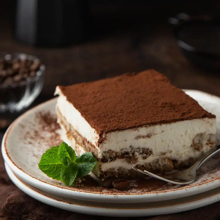 Midnight Tiramisu Fragrance Oil: A large piece of tiramisu dusted in rich dark chocolate on a platter