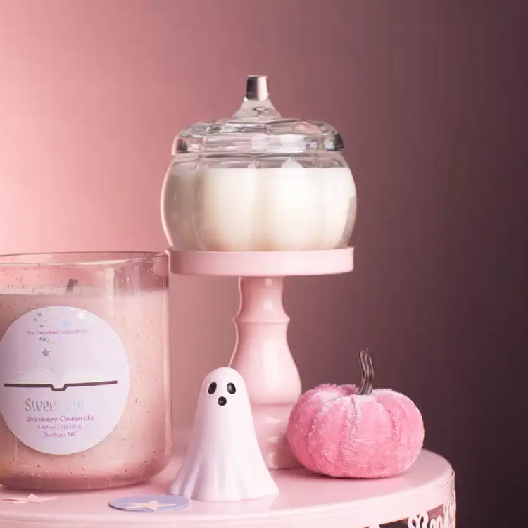 Mini Clear Glass Pumpkin Jar  on a pink podium