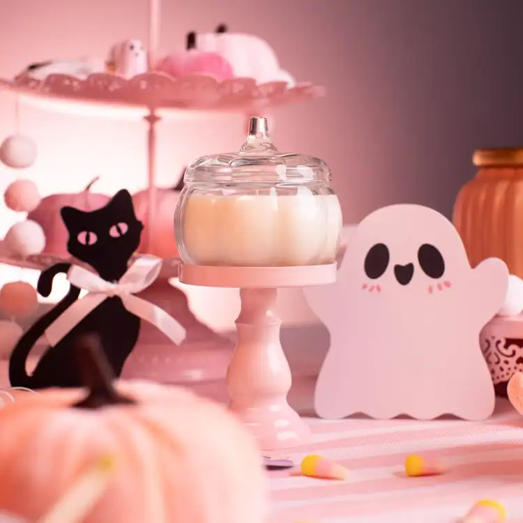 Mini Clear Glass Pumpkin Jar on a pink podium with cute ghosts around it