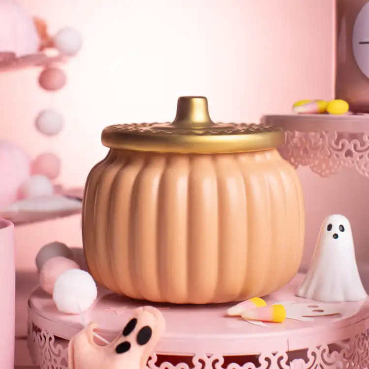 Harvest Orange Ceramic Pumpkin Jar with Gold Matte Lid on a sweetly spooky pink background