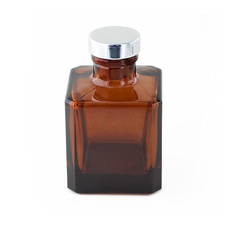 Amber Round Reed Diffuser Bottle with a Siliver Stopper on a white background