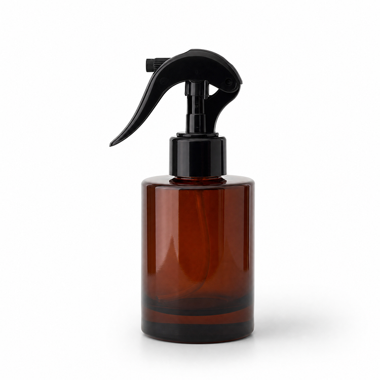 4 oz. Amber Round Glass Bottle a Spray Top/Mister on a white background