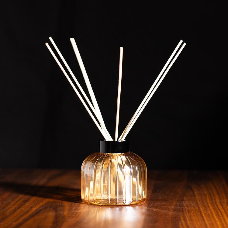 Champagne Luster Gatsby Reed Diffuser Bottle with a Black Gatsby Collar with a moody wood and dark background